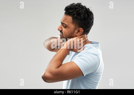 unhealthy indian man suffering from neck pain Stock Photo