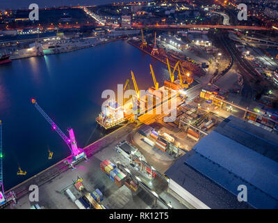 Aerial view container warehouse and working crane bridge loading container for logistics import export or transportation concept background. Stock Photo
