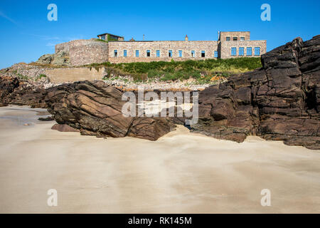Corblets Bay and beach looking toward the Victorian Fort Corblets on Alderney Channel Islands. Stock Photo