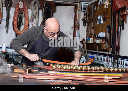 craftsman working the leather in his small workshop Stock Photo