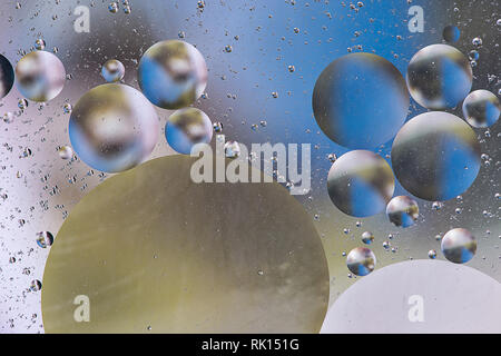 Color drops floating in oil and water over a colorful underground with oil painting effect Stock Photo