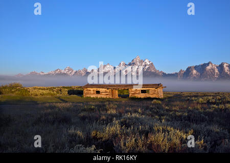 WY03346-00...WASHINGTON - Foggy morning at Cunningham Cabin Historic Site with the Teton Range in the distance in Grand Teton National Park. Stock Photo