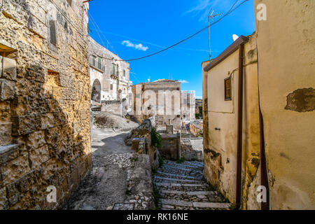 Paths going up and down through in the medieval center of prehistoric Matera Italy in the Basilicata region. The Convent of Saint Agostino is in view Stock Photo