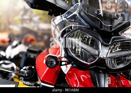 Close up of the front of a brand new enduro motorcycle, soft focus, abstract background - Image Stock Photo