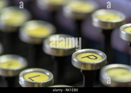 A closeup of the keys on an antique typewriter focusing on the letter P. Stock Photo