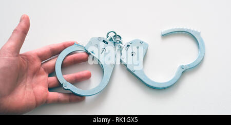 Handcuffs on the wrists of the detained man. Police division. Stock Photo