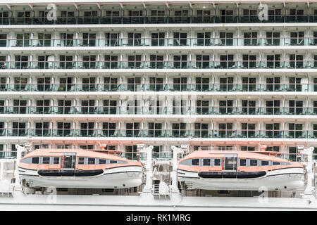 Life boats suspended below cabins on side of cruise ship Stock Photo