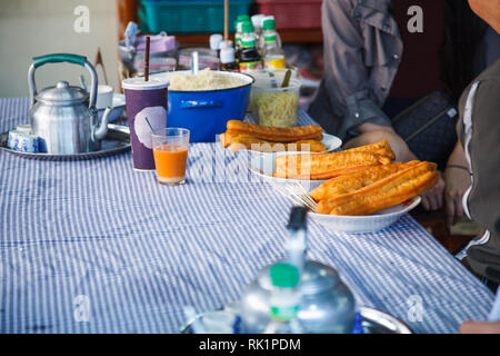 Youtiao (Chinese fried churro, Chinese cruller, Chinese oil stick, Chinese doughnut, fried breadstick), long golden brown deep fried dough strip, eate Stock Photo