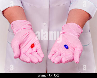 Difficult Choice between drugs and Placebo. Doctor holds pills. Laboratory Reserch. Pharmacy biotechnology science. Hand in pink Gloves with Pill. Hea Stock Photo