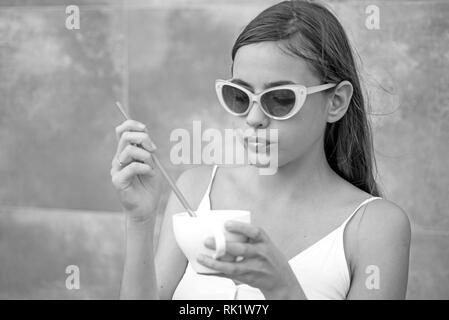 Start the day with great taste. Pretty woman sip beverage with drinking straw. Cute woman drink through straw in cafe. Fashionable woman enjoy sipping Stock Photo