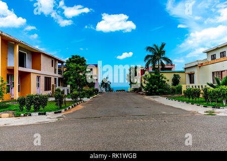 Road crossing in between two building of a  colony at Indian society looking awesome with gardening &  blue sky. Stock Photo