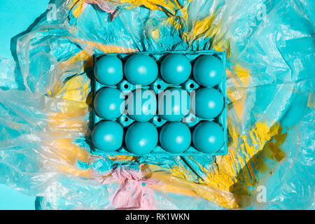 Colourful Easter eggs in rack on cellophane Stock Photo