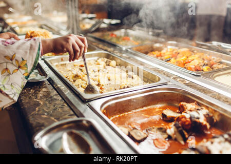 Assortment of fresh dishes displayed in hotel buffet. Variety of food in canteen ready for dinner. Potato and vegetables. All inclusive Stock Photo