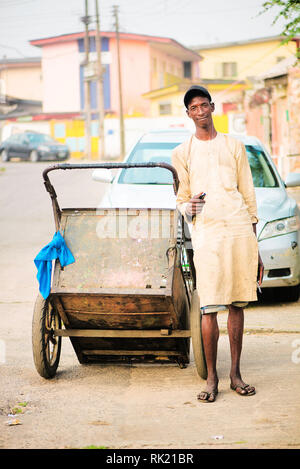 Urban jobs - A scavenger in the streets of Lagos with his cart Stock Photo