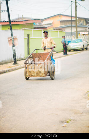 Urban jobs - A scavenger in the streets of Lagos with his cart Stock Photo