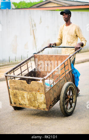 Urban jobs - A scavenger in the streets of Lagos with his cart Stock Photo