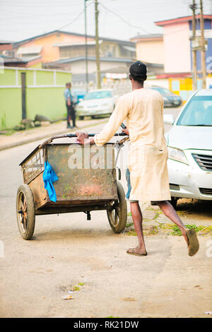 Urban jobs - A scavenger in the streets of Lagos with his cart Stock Photo