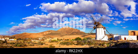 Traditional windmill and moun tains in tefia village,Fuerteventura,Spain. Stock Photo