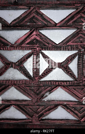 brown wooden texture from old carved ornament pattern on the wall . Stock Photo