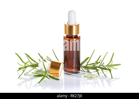 Rosemary essential oil isolated on white background. Rosemary oil for skin care, spa, wellness, massage, aromatherapy and natural medicine Stock Photo