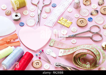 Sewing items on pink background Stock Photo