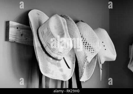 straw hats hanging on wall Stock Photo