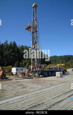 DOBSON, NEW ZEALAND, OCTOBER 13, 2018: Engineers feed the drill string down an old gas well in preparation for capping the well. Stock Photo