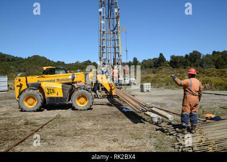 DOBSON, NEW ZEALAND, OCTOBER 13, 2018: Engineers feed the drill string down an old gas well in preparation for capping the well. Stock Photo