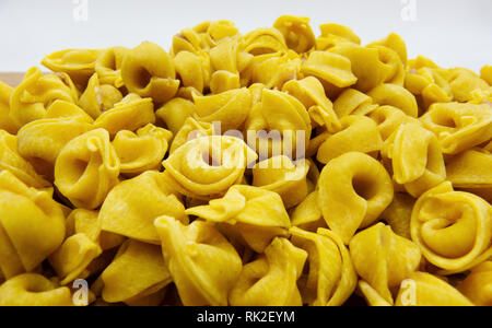Uncooked tortellini close up on white background, italian pasta Stock Photo