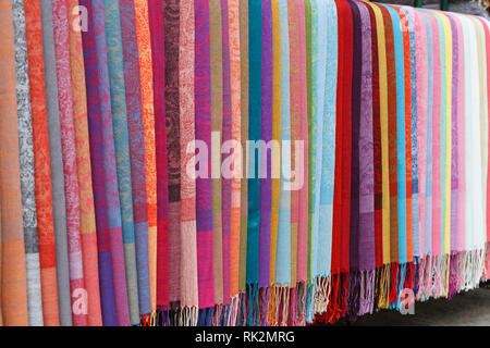 Colorful silk scarves on display in street market Stock Photo