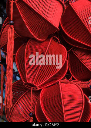 Closeup of group of red silk lanterns hang in local street market Stock Photo