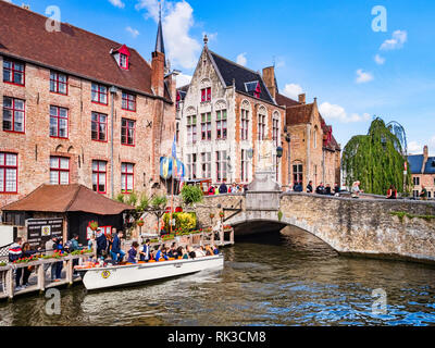 25 September 2018: Bruges, Belgium - Tourists boarding a tour boat on the canal by the Wollestraat Bridge in Bruges. Stock Photo