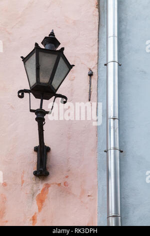 Traditional vintage street light mounted on old house wall in Tallinn, Estonia Stock Photo