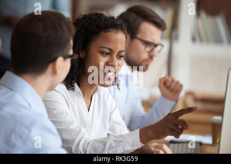 African young intern or mixed-race new employee talking to mentor Stock Photo