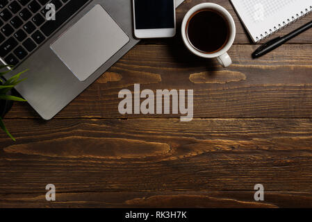 Working place top view with laptop, phone, coffee and notebook Stock Photo