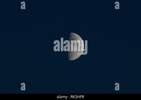 Half-Moon Real Picture of Moon on dark night cloudless sky Stock Photo