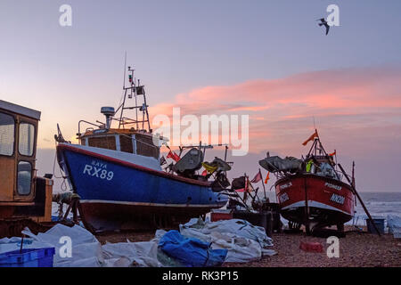 Hastings, East Sussex, UK. 9th February 2019. Fishing boats at dawn on the Stade Fishing Boat beach, on a mild blustery day. Stock Photo