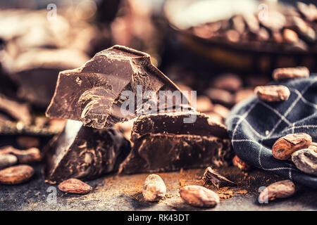 Dark chokolate cocoa beans and powder on concrete table Stock Photo