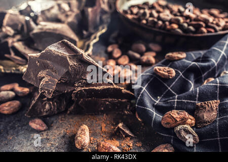 Dark chokolate cocoa beans and powder on concrete table Stock Photo