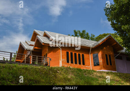 Wooden house on grass hill at summer day in Koh Lipe, Thailand. Stock Photo