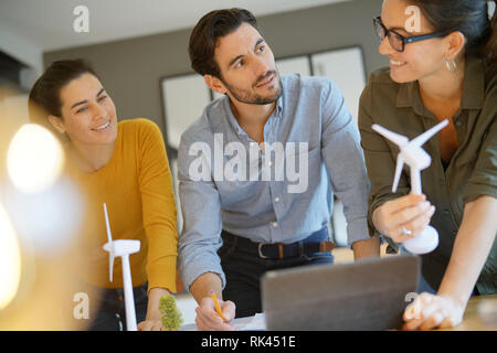 Attractive wind farm engineers looking over turbine placements Stock Photo