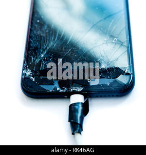 Cell phone with the screen broken by a hammer. non-warranty repairs concept. Stock Photo