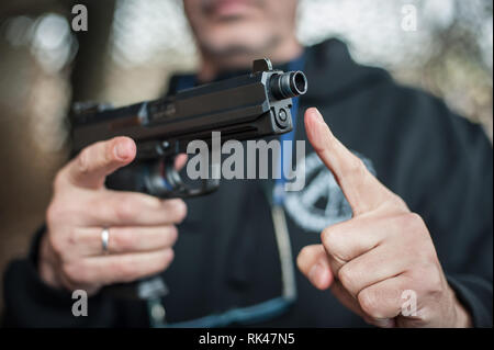 Gun Silencer. Sound suppressor for reduces the sound intensity of handgun and pistol Stock Photo