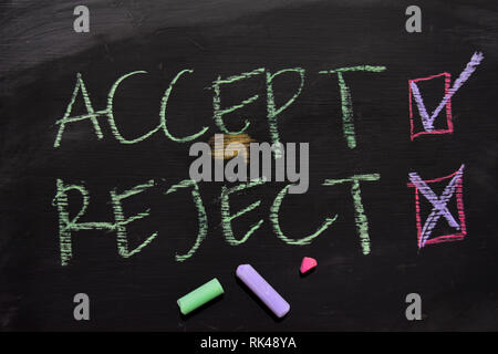 Accept or Reject written with color chalk concept on the blackboard Stock Photo