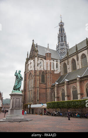 Haarlem, The Netherlands - 25 October 2013: The large or Sint Bavo church in the old centre of Haarlem with statue of Laurens Janszoon Coster, presume Stock Photo