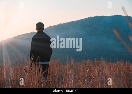 Silhouette of a man on a mountain. Stock Photo