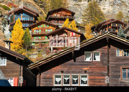 Wood houses and chalet surrounded by yellow larch trees, Zermatt, canton of Valais, Switzerland Stock Photo