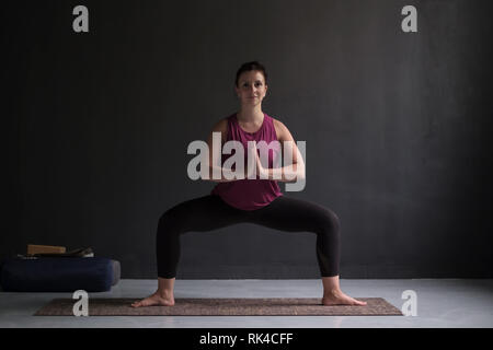 Sporty girl doing sumo squat exercises or revolved temple, Goddess Stock  Photo - Alamy