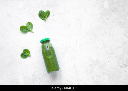 Green Smoothie Bottle  with heart shaped spinach on white background, top view. Detox, clean eating, diet and healthy eating concept, copy space. Stock Photo