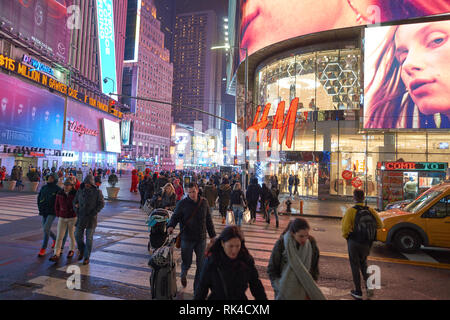 NEW YORK - CIRCA MARCH 2016: Times Square H&M store at night. H & M Hennes & Mauritz AB is a Swedish multinational retail-clothing company, known for  Stock Photo